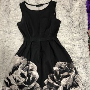 Black form fitting dress that flares out to make any occasion a perfect choice .